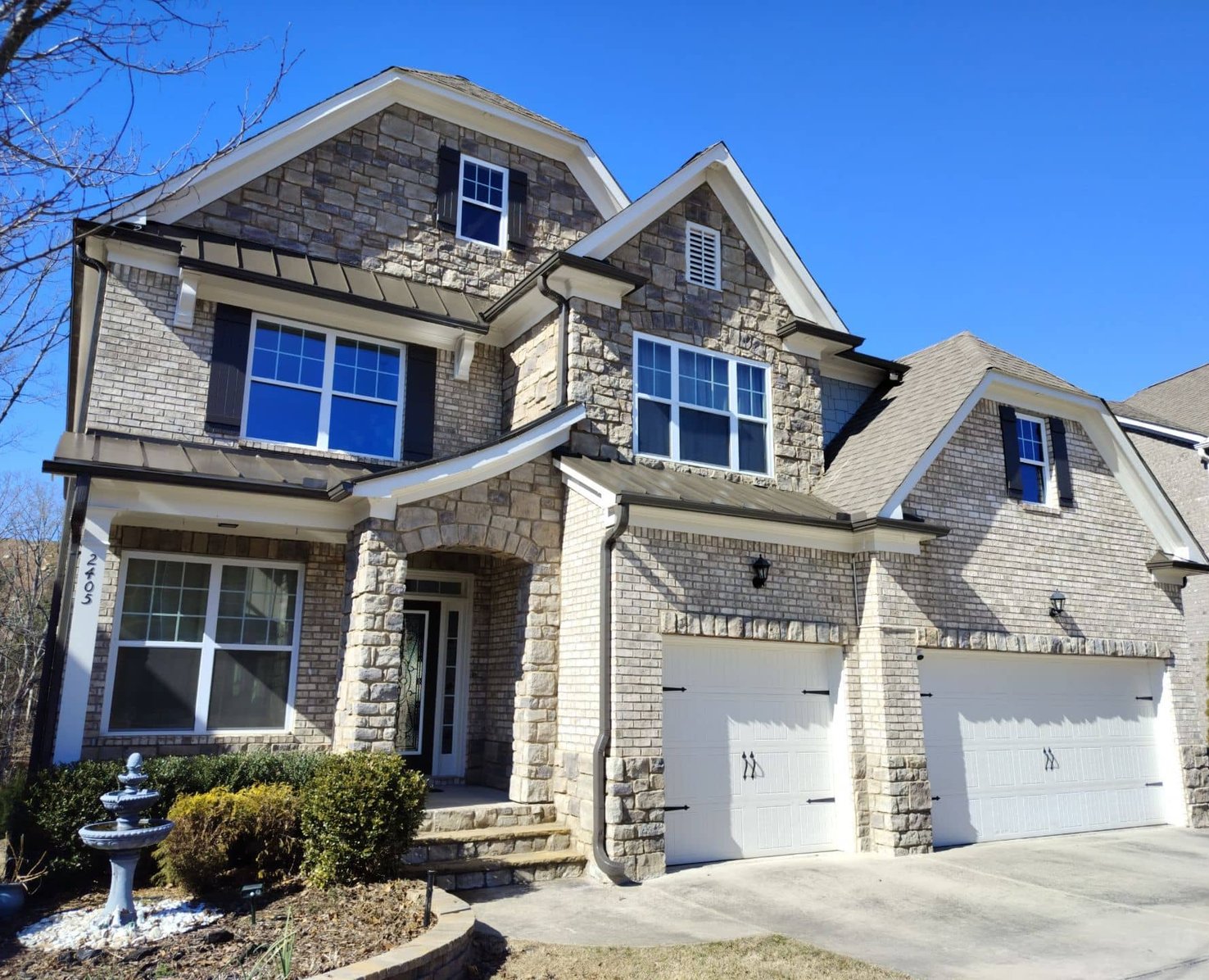 Exterior of a freshly painted stone and brick home in Georgia